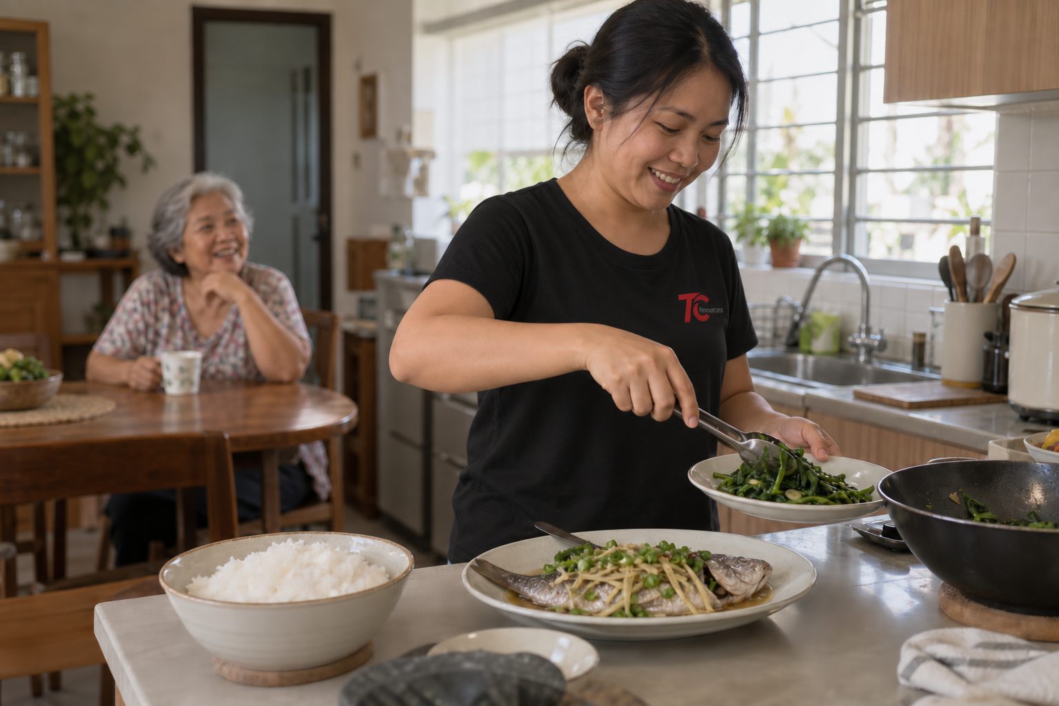 A helper plating a home-cooked meal of rice, steamed fish and greens while an elderly woman looks on